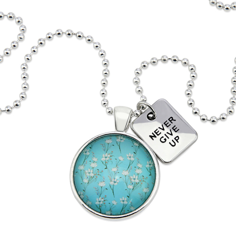 Teal floral print pendant necklace in bright silver with never give up charm. 