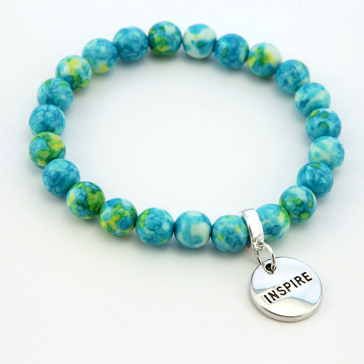 Stone bracelets with blue and green stone beads and silver charms with the words 'strength', 'loved', and 'inspire' on them.