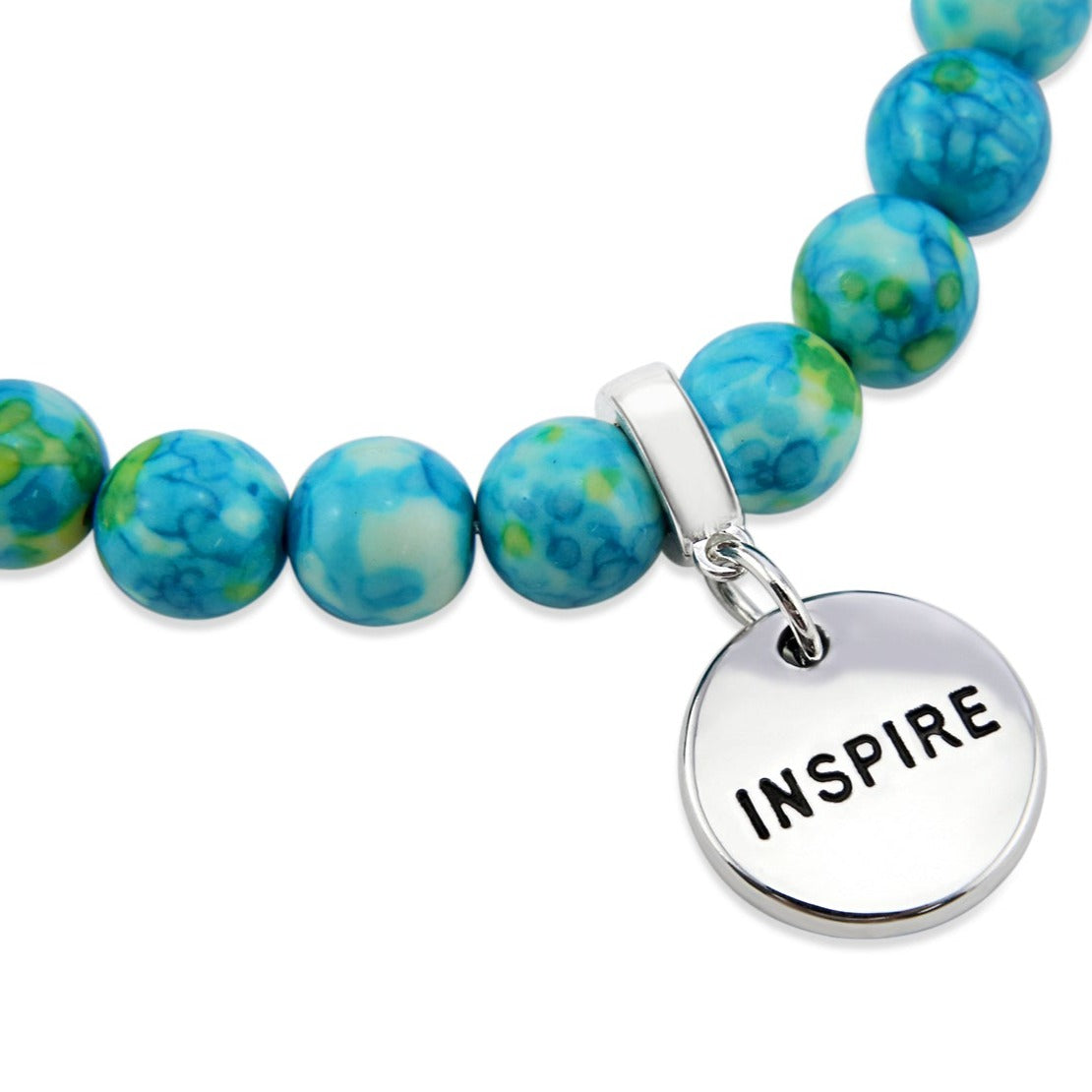 Stone bracelets with blue and green stone beads and silver charms with the words 'strength', 'loved', and 'inspire' on them.