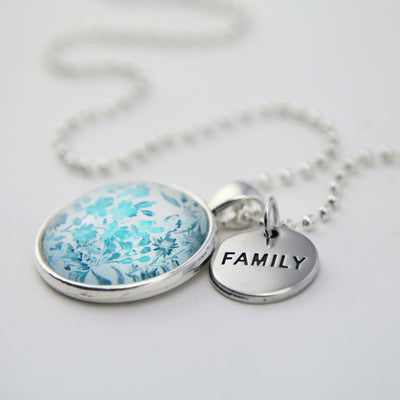 Teal print floral pendant necklace in bright silver with family charm.