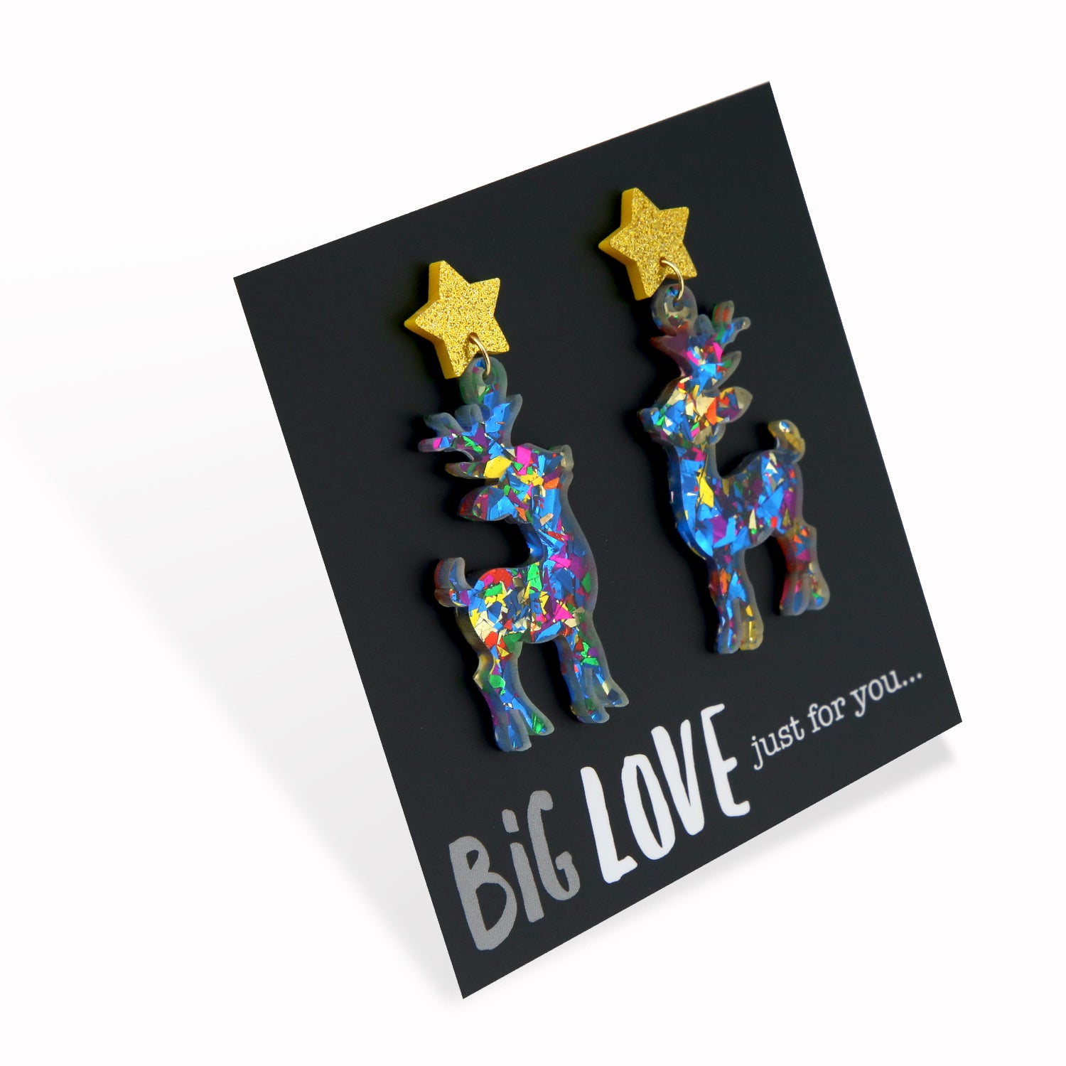 A pair of colorful acrylic and resin dangle earrings featuring glittery reindeer shapes with star accents, displayed on a black background with the text 'BIG LOVE just for you.
