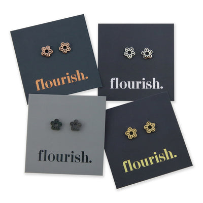 Flower Power stainless steel studs in rose gold, silver, black, gold on a foil flourish card.