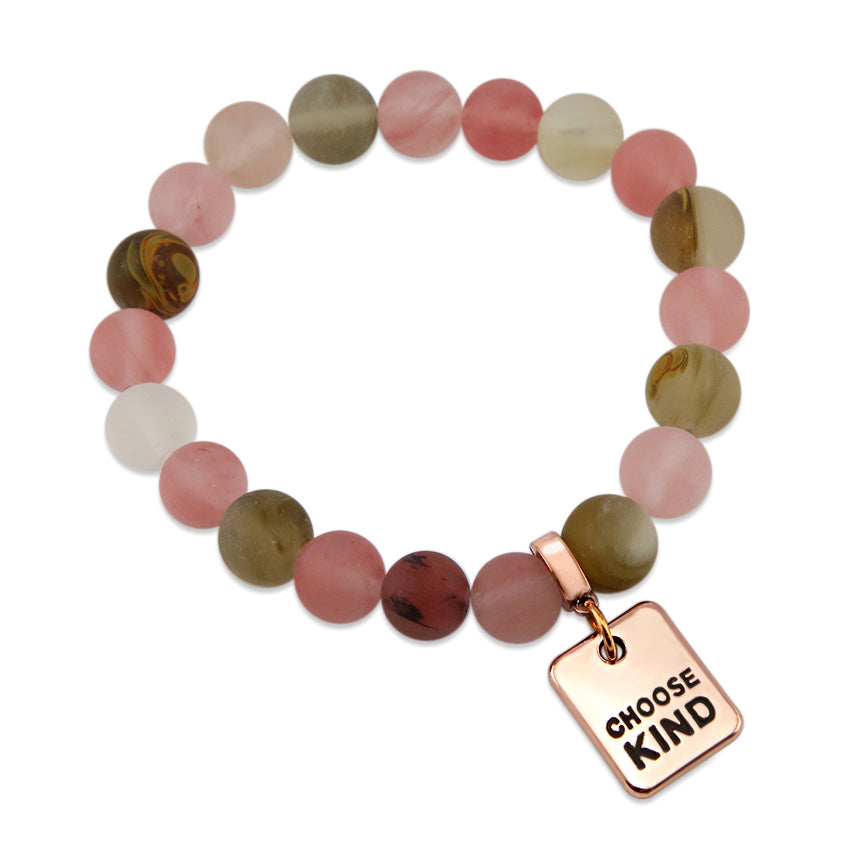 A collection of stone bracelets with rose gold charms, featuring beads in pink and earthy tones, with charms that say 'LOVE', 'I AM ENOUGH', 'CHOOSE KIND', and 'LOVE MY TRIBE'.