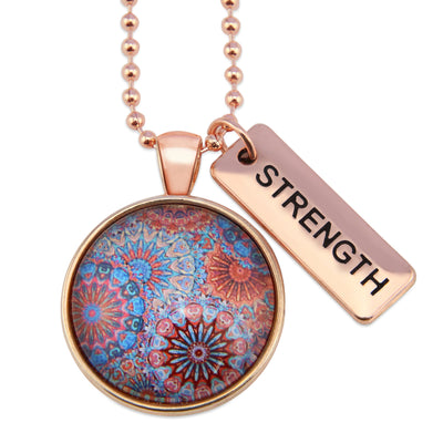 Red, blue, and orange patterned print pendant necklace with rose gold ball chain and Strength word charm.