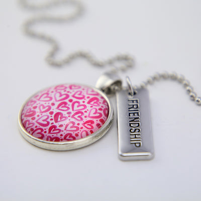 Pink heart print necklace with friendship charm set in silver