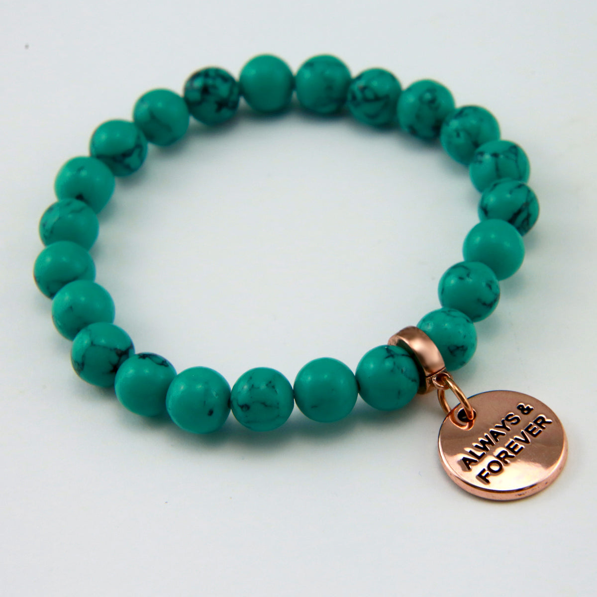 Teal coloured stone bead bracelet with rose gold charm