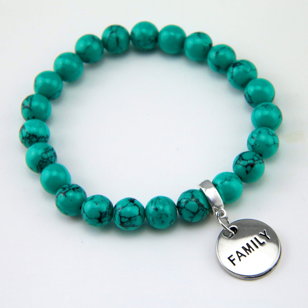 Teal coloured stone bead bracelet with silver meaningful word charm. 