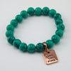 Teal stone bead bracelet with rose gold charm.