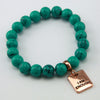 Teal stone bead bracelet with rose gold charm.