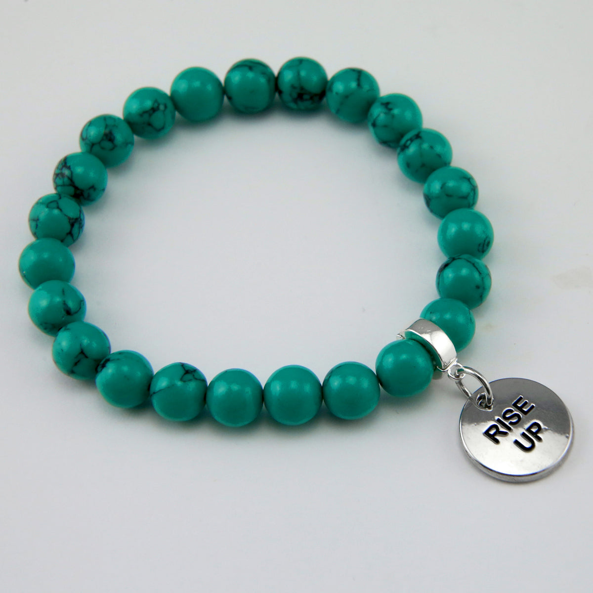 Teal coloured stone bead bracelet with silver meaningful word charm. 