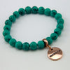 Teal coloured stone bead bracelet with rose gold charm