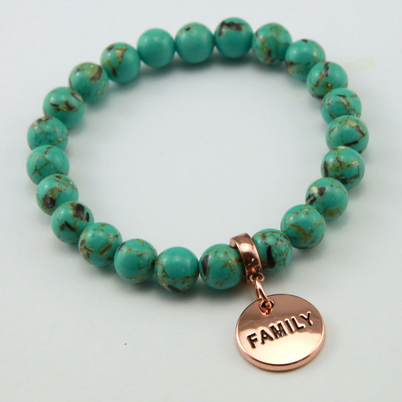 Light teal stone bead bracelet with rose gold meaningful word charm. 