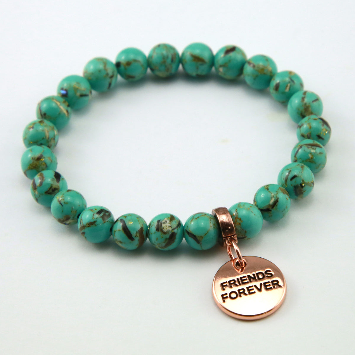 Light teal stone bead bracelet with rose gold meaningful word charm. 