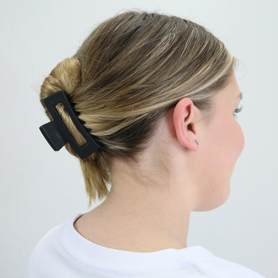 Girl wearing hair claw clip to demonstrate size.