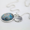 Teal print mandala pendant necklace in bright silver with courage charm.