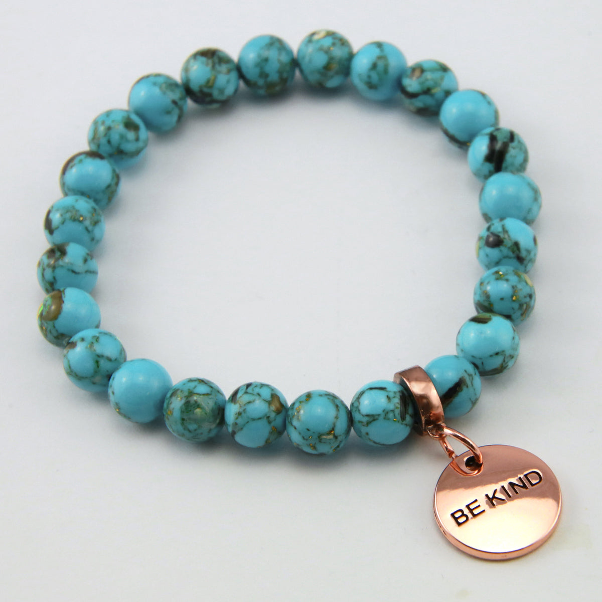 Teal coloured stone bracelet with word charm and rose gold clip. 