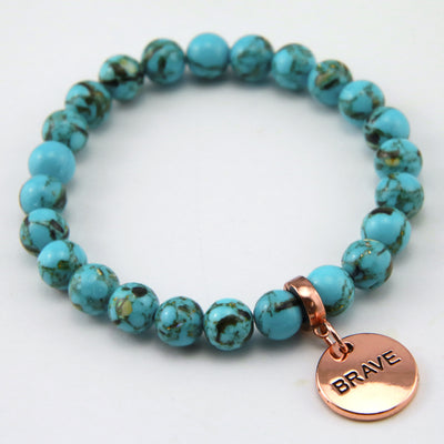 Teal coloured stone bracelet with word charm and rose gold clip.