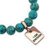 Teal coloured stone bead bracelet with rose gold meaningful word charm.