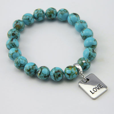 Teal coloured stone bracelet with word charm and silve r clip.