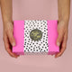 Pink box with black and white potted wrapping and black Sister & Soul sticker, with hands holding it out front on a pink background. 