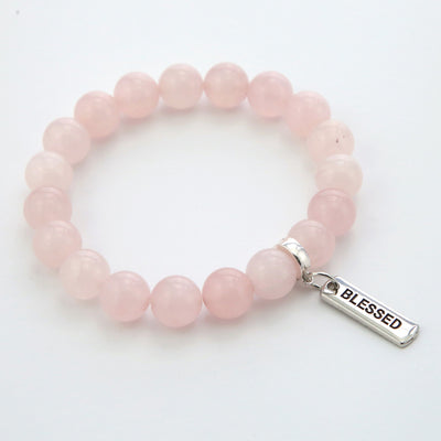 Rose quartz stone bead bracelet with silver clip and inspiring word charm.