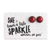 She leaves a little sparkle wherever she goes earring gift card with 12mm ruby red glitter earring studs with vintage copper circle surround.