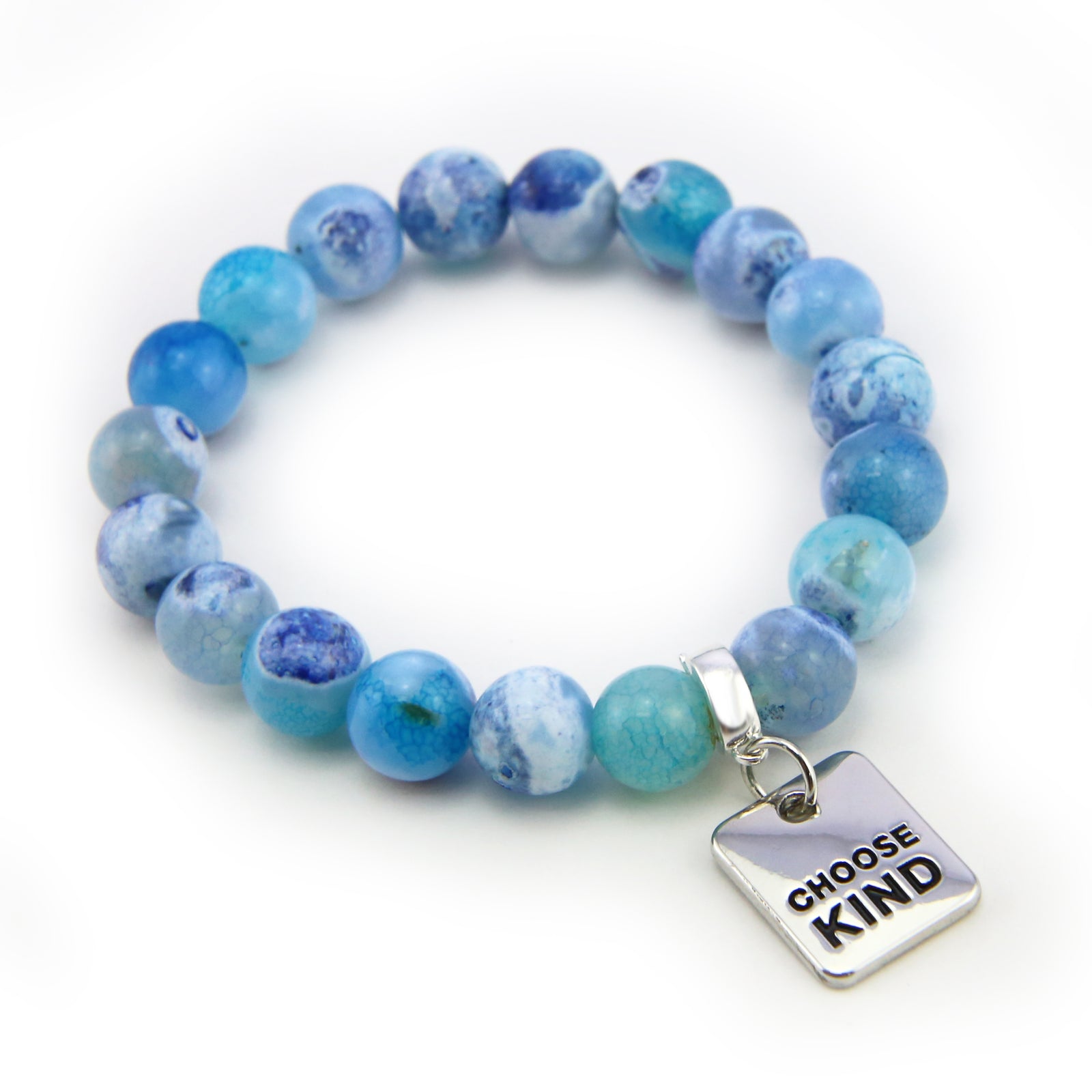 Person wearing a blue beaded bracelet with a 'LOVE' charm, holding jeans.