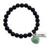 Matt black onyx stone beaded bracelet with feature green adventurine stone heart charm and inspiring word charms in silver.