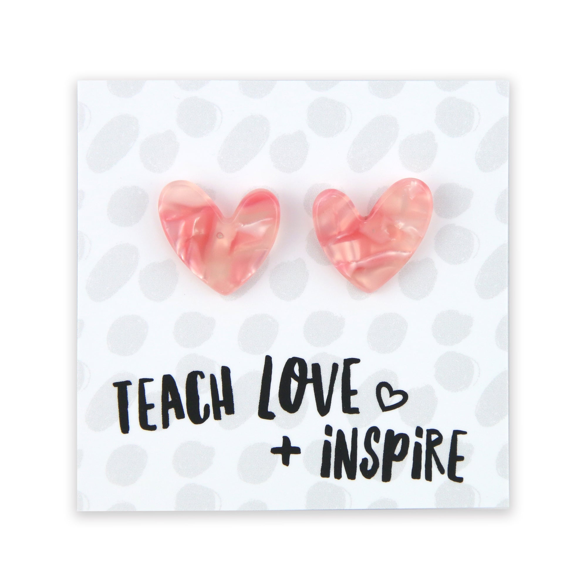 Pinky peach coloured resin heart earrings on Teach, Love Inspire card. 