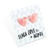 Pinky peach coloured resin heart earrings on Teach, Love Inspire card.