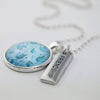 Teal tea cup print pendant necklace in bright silver with friendship charm.