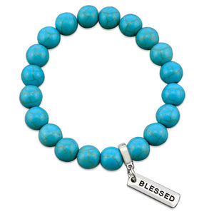 Turquoise stone bead bracelet with silver charms with meaningful words. 
