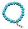 Turquoise stone bead bracelet with silver charms with meaningful words.