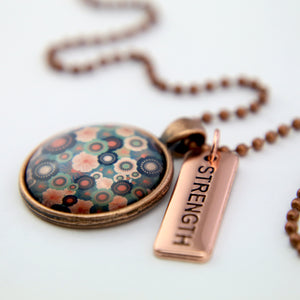 Teal floral print rose gold pendant necklace with strength charm. 